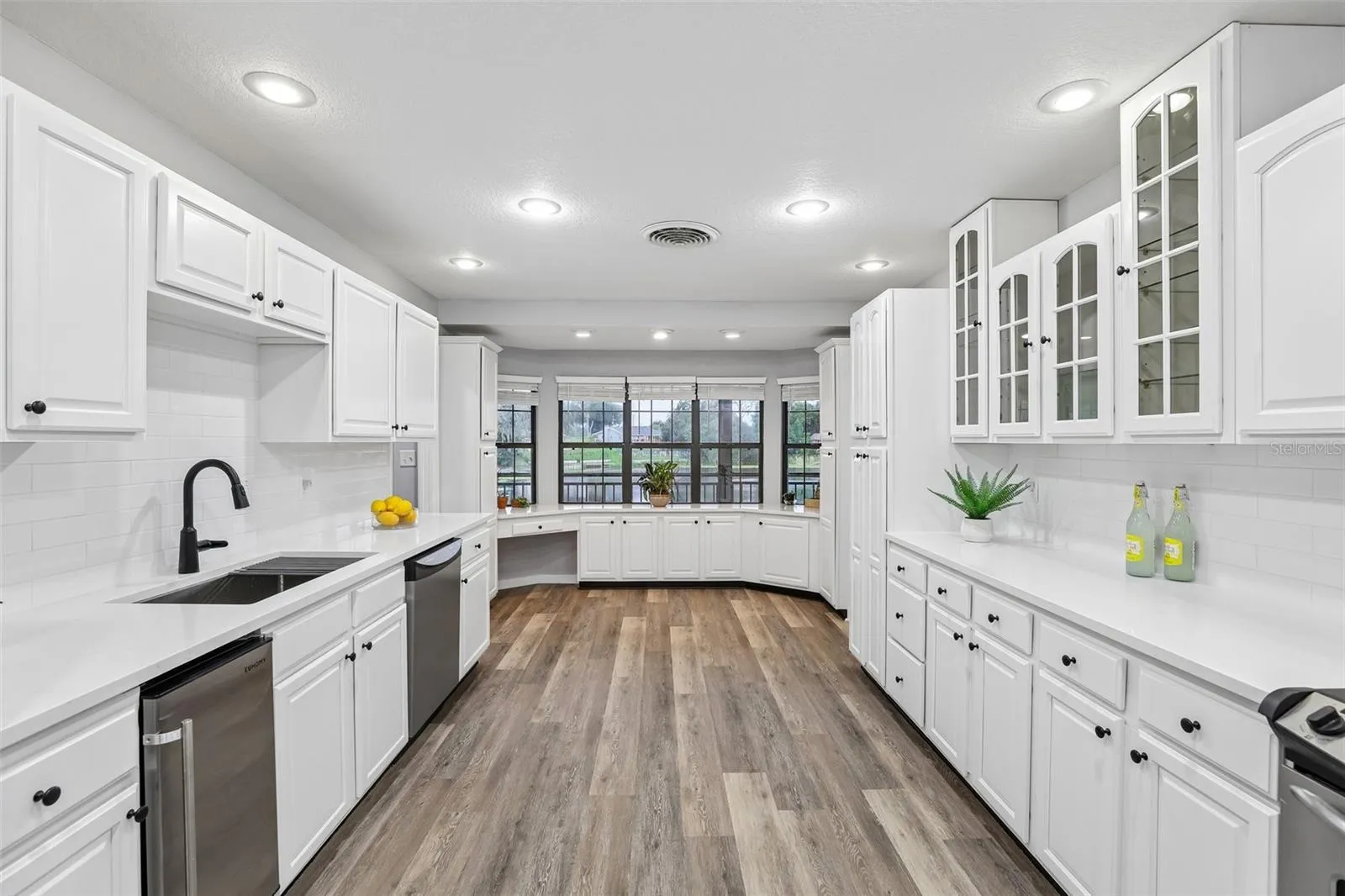 Freshly updated Kitchen-Feashly painted cabinets, Quartz counters, subway tile, undermount sink, hardware and new faucet.