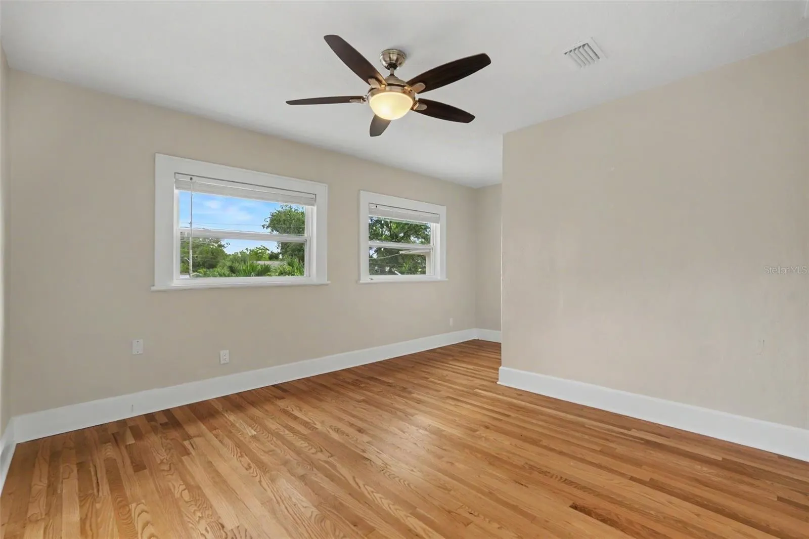 The bedroom offers hardwood floors, abundant natural light, and plenty of room to create a comfortable retreat.