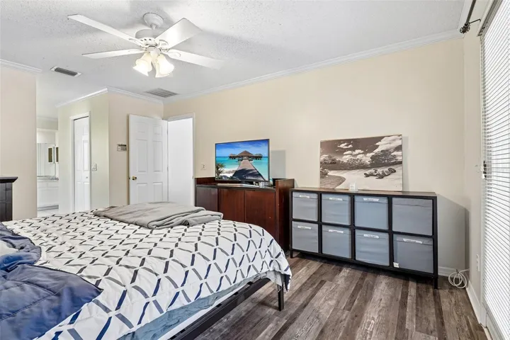 Spacious master bedroom with walk in closet and ceiling fan