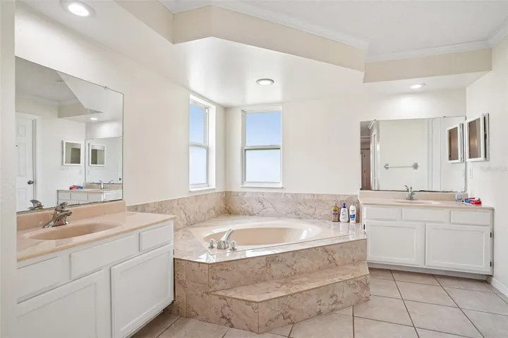 Spacious bathroom with bath tub, shower and double vanity sinks