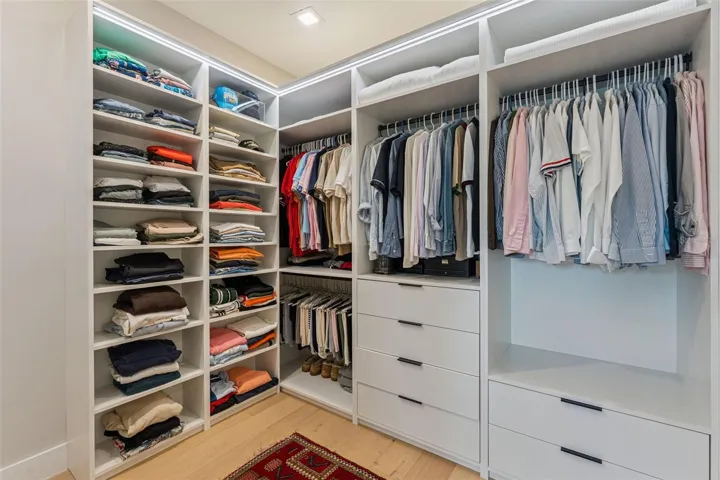 Primary walk in closet with custom dawn and night lighting.