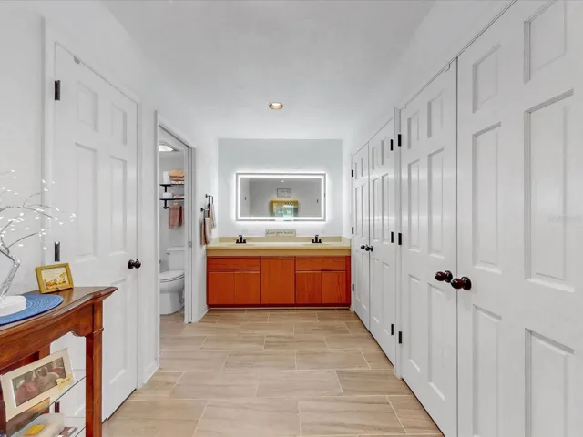 The en-suite bathroom area of the Primary bedroom. Closets to the right and the left