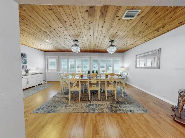 Just off the living area is a gorgeous Dining Room area, and another unique wood plank ceiling