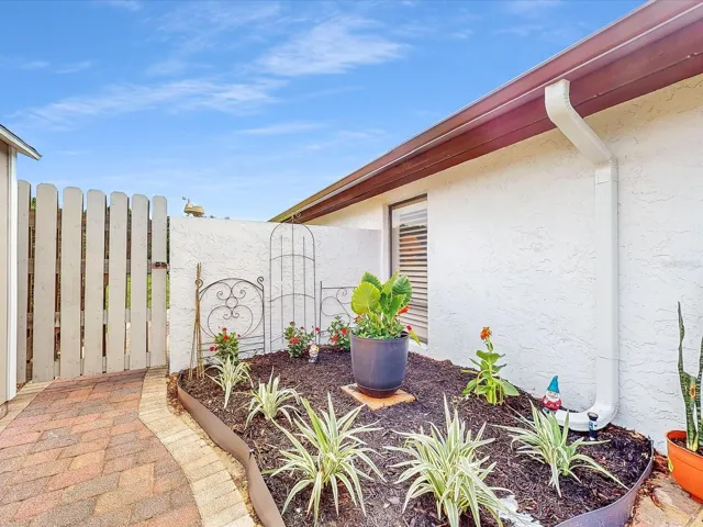 The back gate, entrance into the back yard. Right next to the flower bed area