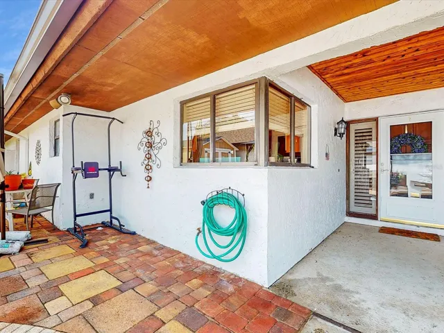 Front door, Large kitchen windows center of picture