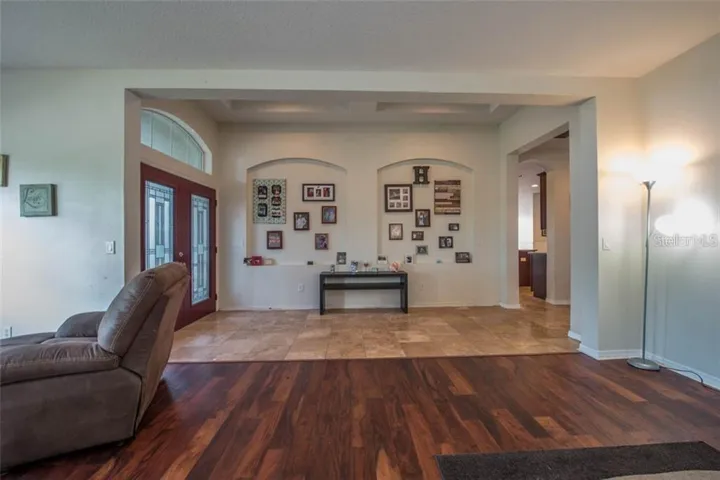 Grand entry way with wood and travertine floors