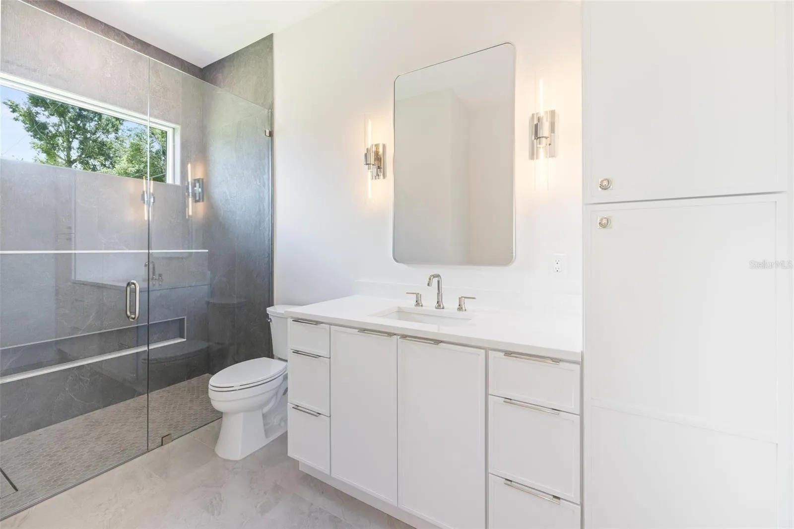 Bedroom 3 enjoys a private en-suite bath with direct exterior access to the lanai, providing an ideal guest retreat and future pool bath.