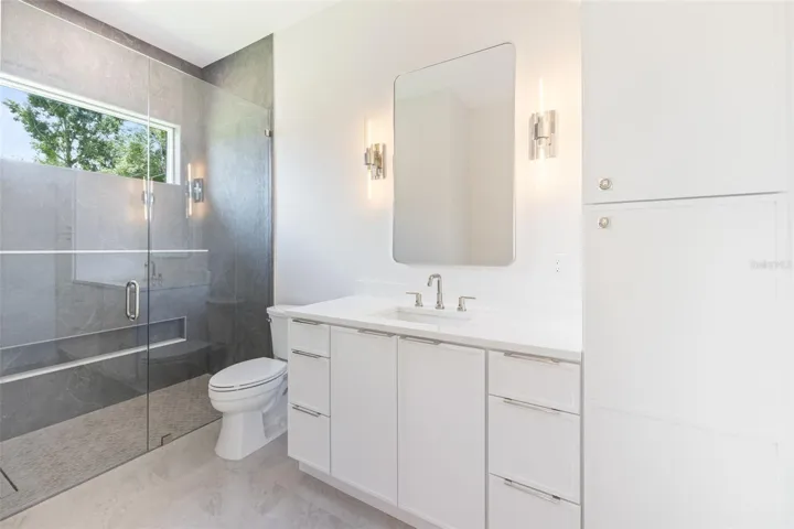 Bedroom 3 enjoys a private en-suite bath with direct exterior access to the lanai, providing an ideal guest retreat and future pool bath.
