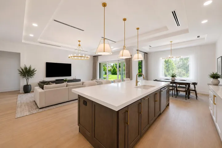 Virtually staged.The gourmet kitchen is a true showpiece, featuring full-height custom cabinetry, an oversized 11-foot quartz island with storage on both sides, marble backsplash, GE Profile appliances, custom range hood, cooktop, wall oven, and soft-close cabinetry throughout.