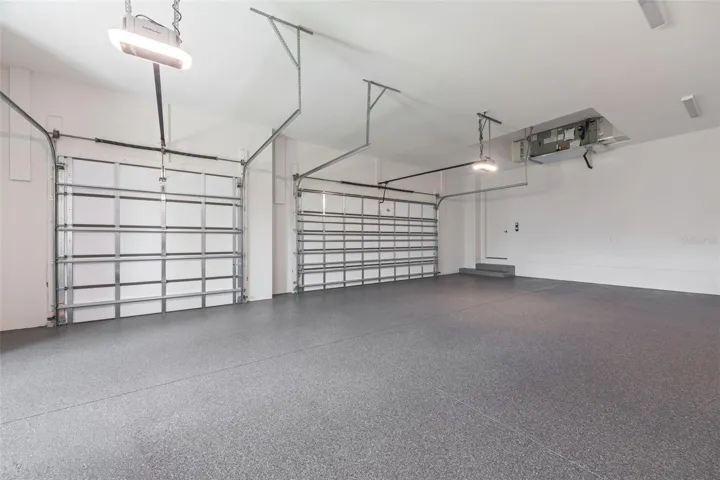 Oversized 3-car garage with industrial-grade epoxy flooring, Wi-Fi garage door openers, and impressive 11-foot ceilings.