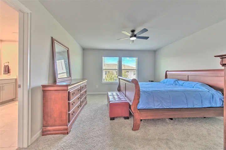 Owner's Suite with Ceiling Fan and Water View