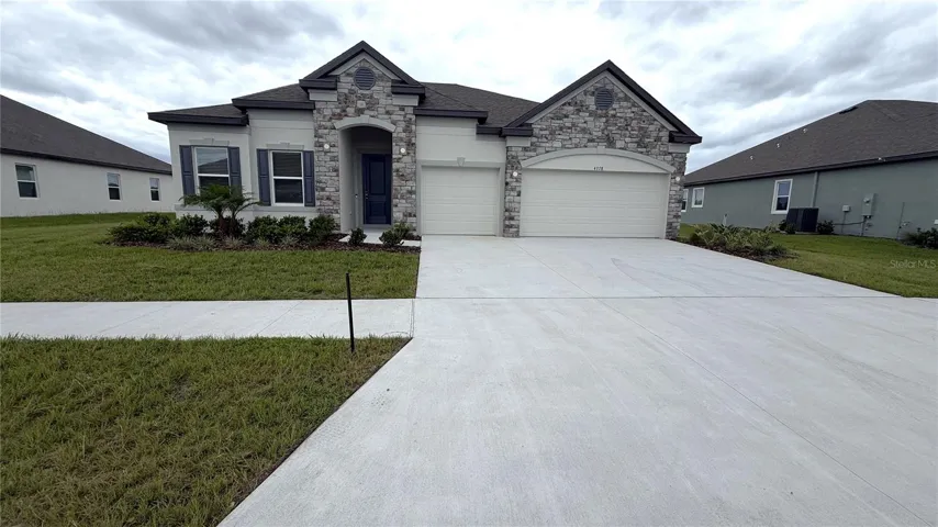 Stunning Exterior, block construction, w/stone accent, 3 car garage