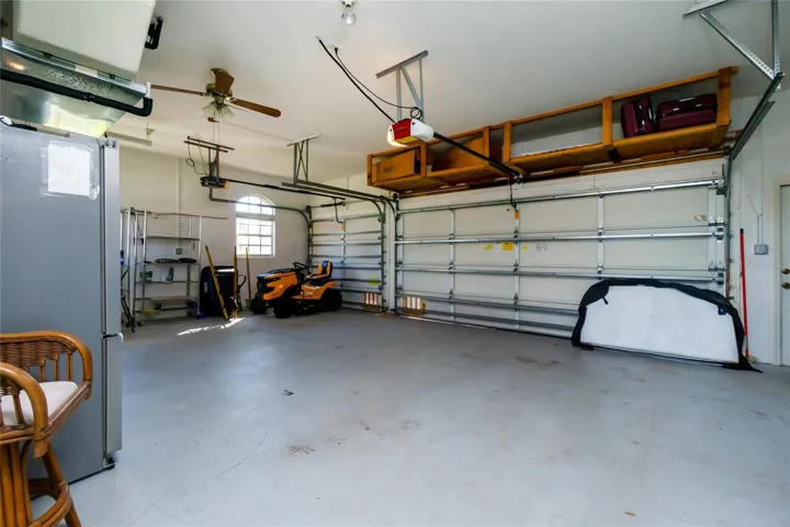 A three car garage is ready to park your toys in the shade.