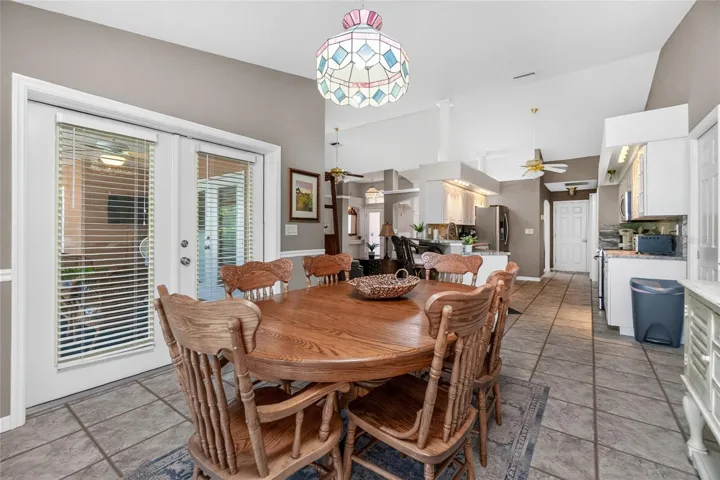 Opposite view of the Dining room Showing the proximity to the Kitchen as well Main Living room. Exterior door give you access to the expansive covered pool deck area for more dining and relaxation options.