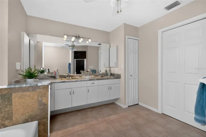 Dual sink vanity with beautiful modern touches continue in the Primary Suite Bathroom.