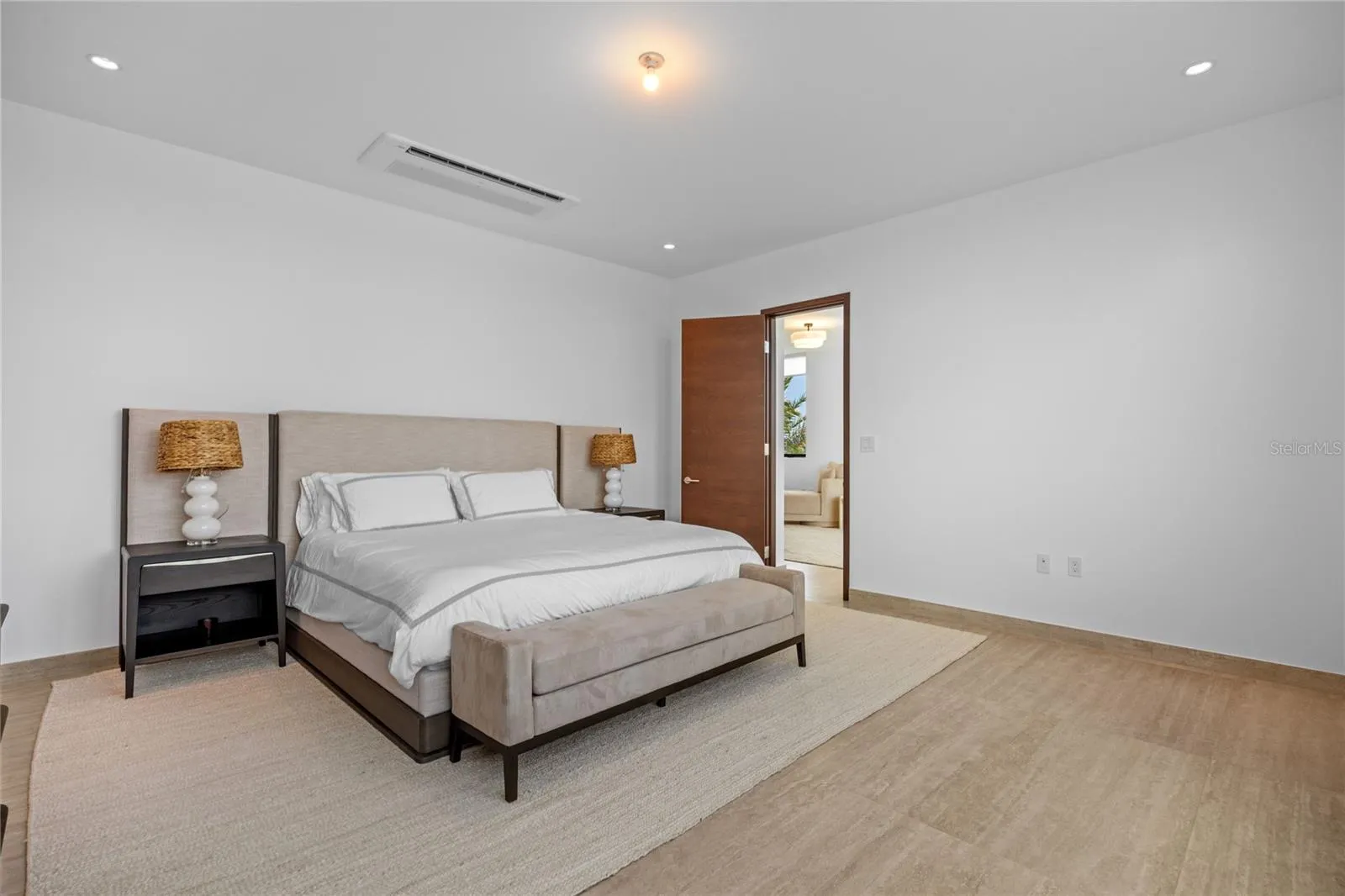 Occupying its own private wing, the primary suite is a standout feature of the residence. In addition to the spacious bedroom and luxurious bath, the suite includes a separate office or lounge area with access to a covered balcony, providing the perfect space to work, relax, or enjoy peaceful views.