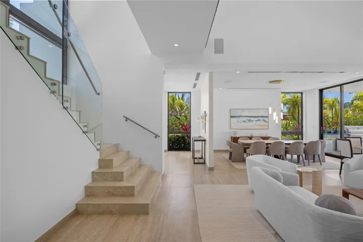 The main level is thoughtfully designed for both everyday living and entertaining, offering a formal dining room, a guest bedroom, additional storage space, and a spacious family room.