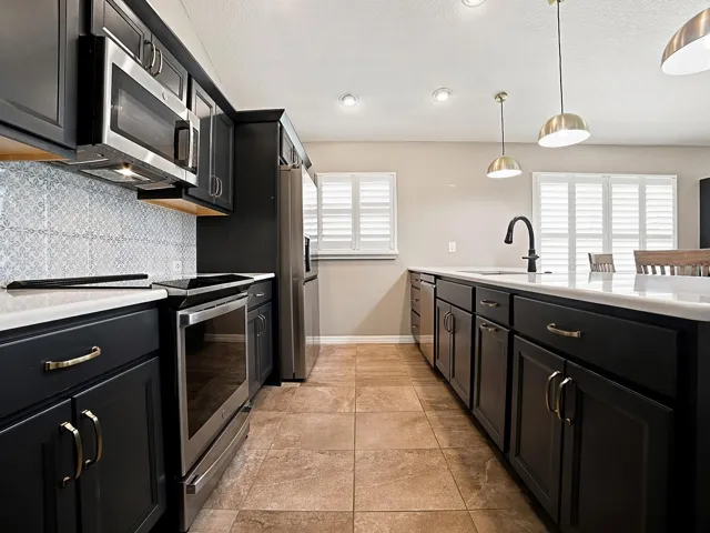 BUILT-IN SMOOTH TOP INDUCTION STOVE - ALL STAINLESS APPLIANCES.