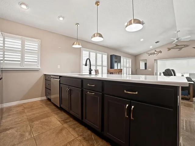 PENDANT LIGHTING AND QUARTZ COUNTERTOPS.