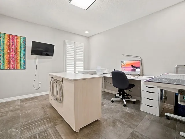 THIS GUEST ROOM IS OFF THE FOYER AND IS BEING USED AS ANOTHER OFFICE AND SEWING ROOM.