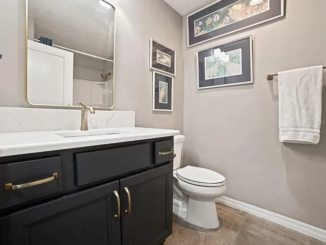 GUEST BATH WITH SAME LOVELY HARDWARE YOU WILL FIND THROUGHOUT THE HOME, AND QUARTZ COUNTERTOPS. THIS GUEST BATH HAS A TUB/SHOWER.