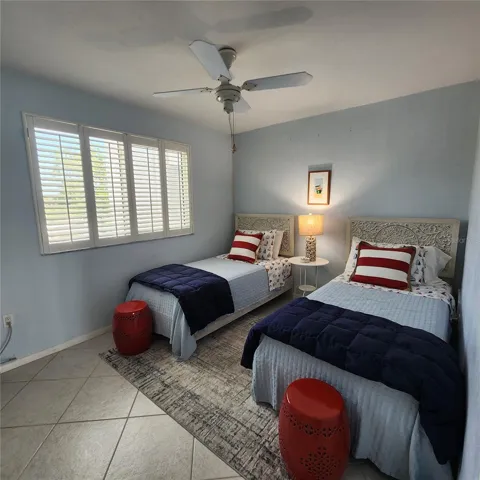 Bedroom two offers twin beds, plantation shutter and built in closet