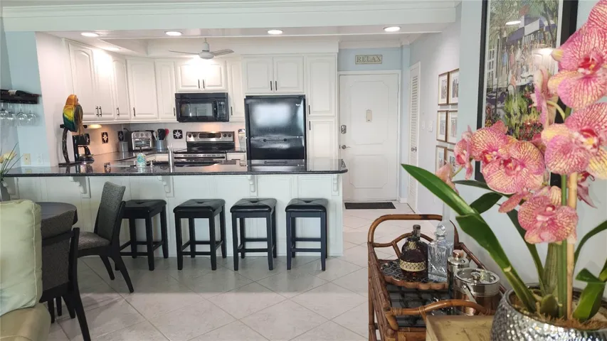 This view shows the front entry door to the right of the kitchen
