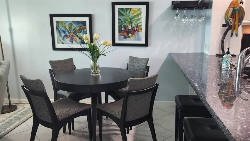 Tucked between the kitchen and living area is a dining space, with seating at a table or countertop