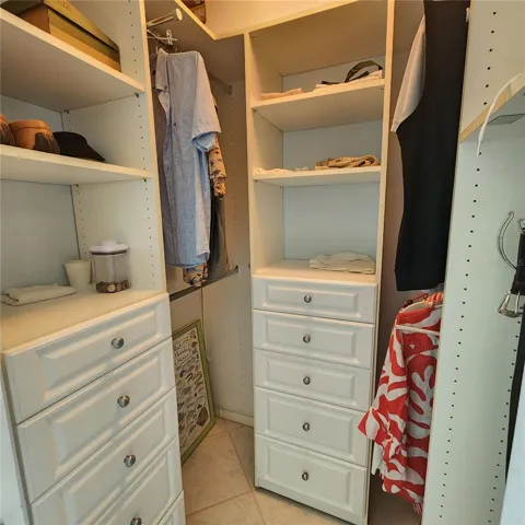 The walk-in closet with custom cabinetry in the primary suite