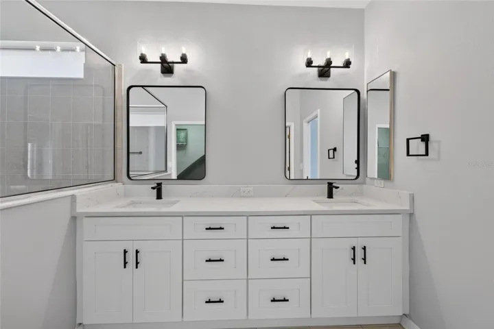 Brand new shaker cabinets, quartz countertops, mirrors and hardware