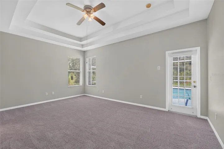 owners suite with pool door, new paint and carpet