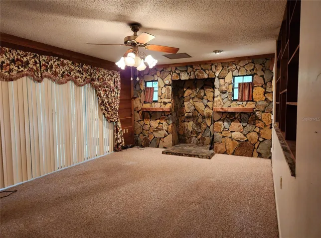 LR WITH STONE DECORATIVE FIREPLACE