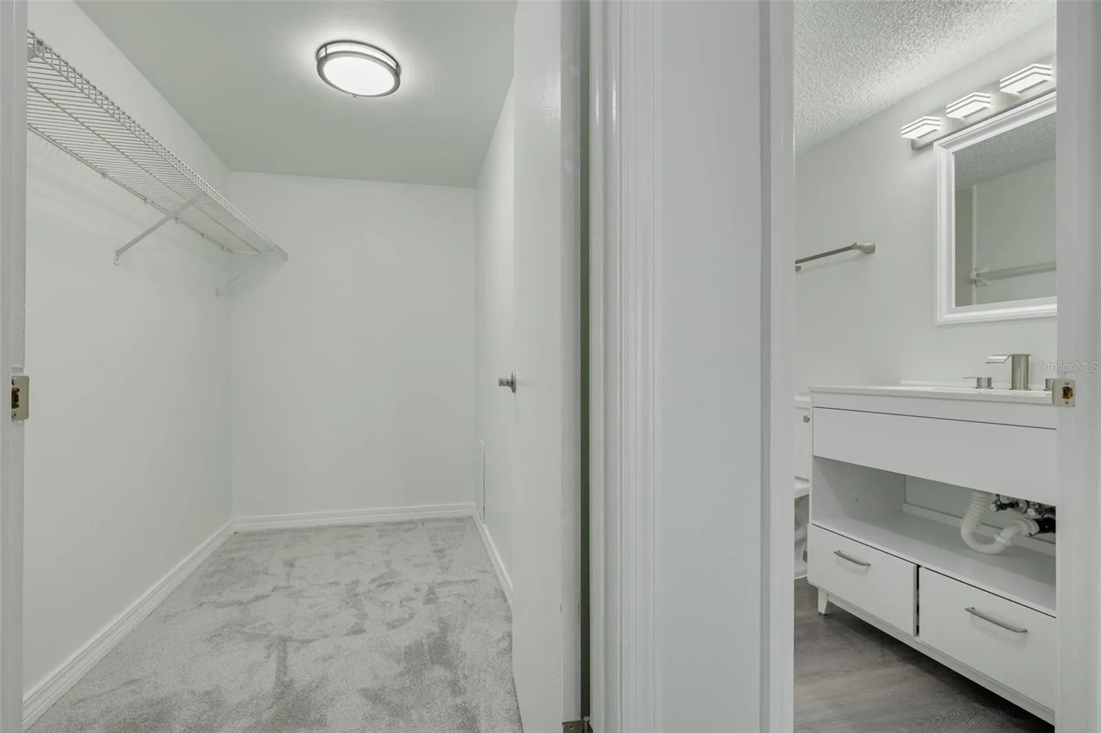 Primary bedroom walk in closet