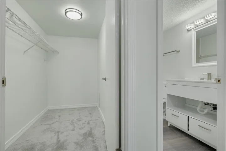 Primary bedroom walk in closet