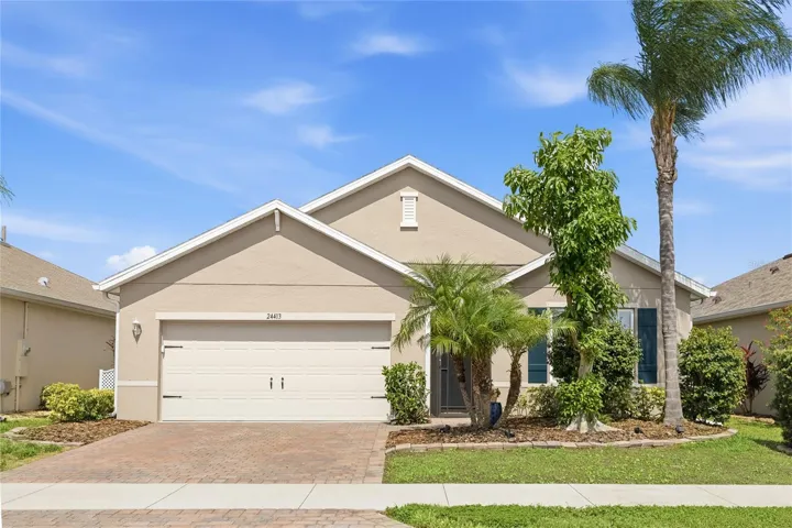 Front of home with Lush Landscaping and screen enclosed foyer.