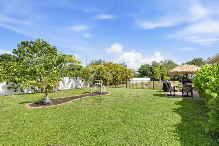 Paver Patio off the Lanai to extend the functional outdoor apace and a large complete fenced in yard.