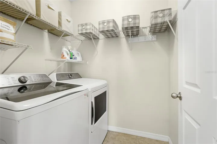 Large Laundry Room with additional shelving for storage.