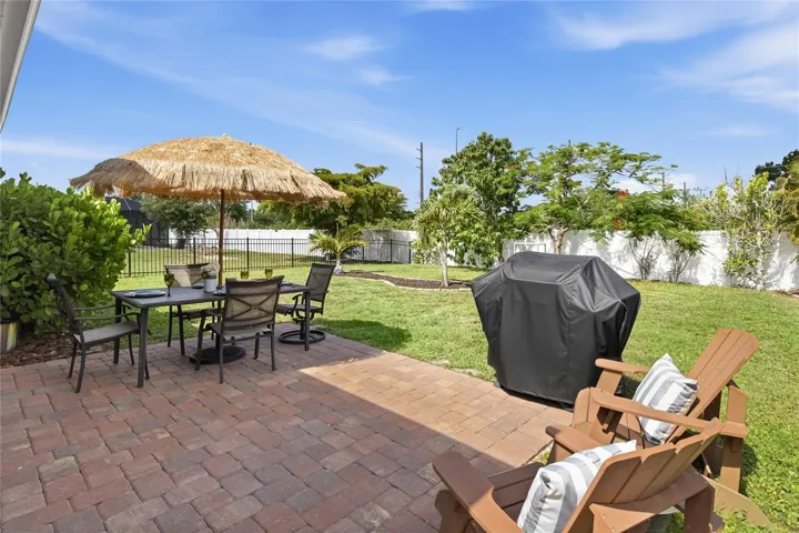 Paver Patio off the Lanai to extend the functional outdoor apace and a large complete fenced in yard.