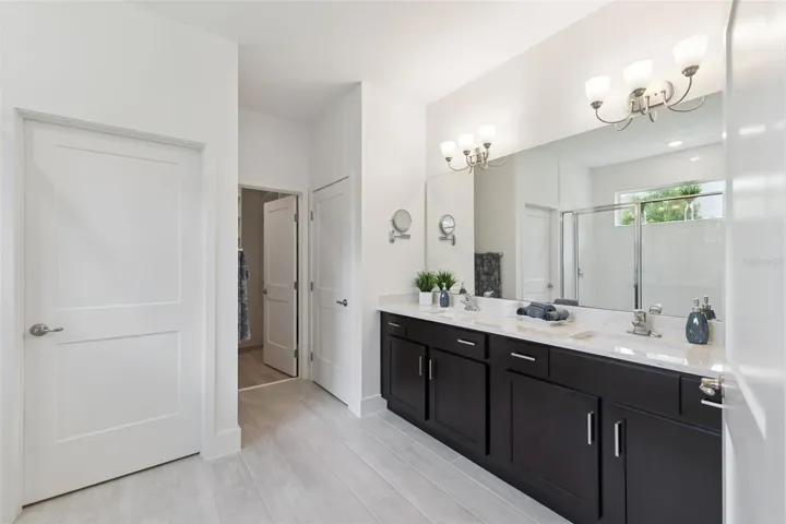 Primary Bathroom with Quartz Counters, Dual Sinks and Linen Closet