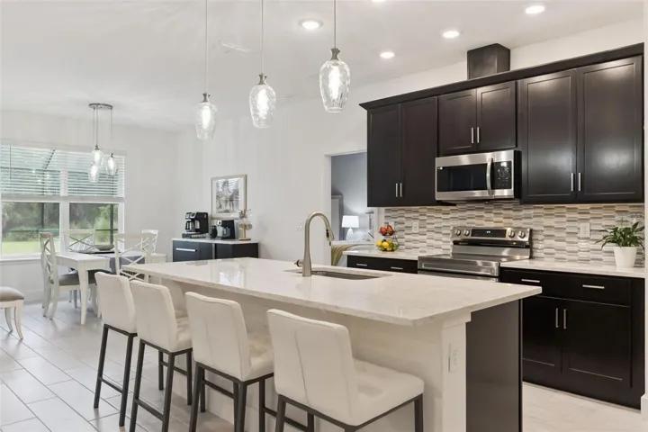 Oversized Quartz Island with Single Deep Sink and Custom Lighting