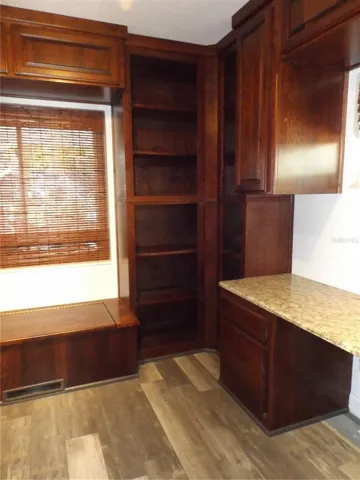 Bench below window that also serves as storage. to the right is built in desk/vanity space.