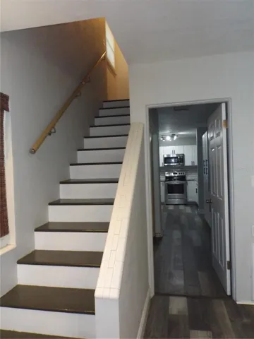 to the right of the staircase is another entrance to laundry/kitchen area