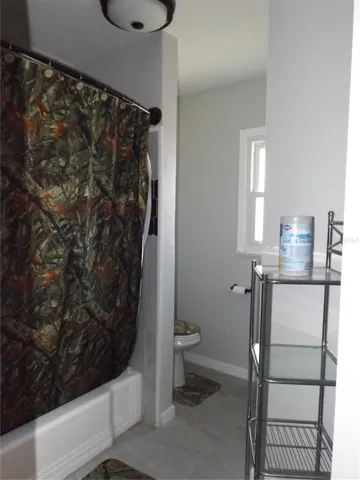 Shower and toilet separated from sink area