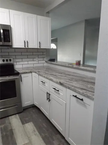 Kitchen to the right of the stove/bar area