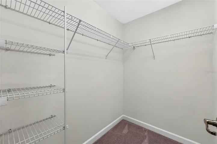 Primary bedroom walk in closet 2