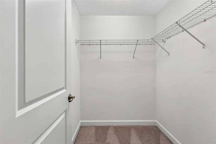 Primary bedroom walk in closet 1