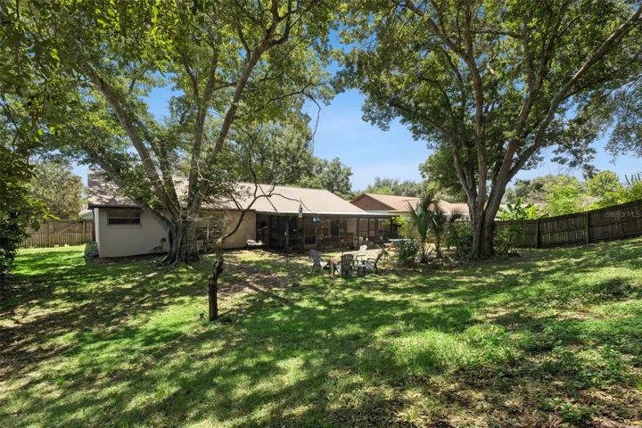 large shaded and fenced in backyard