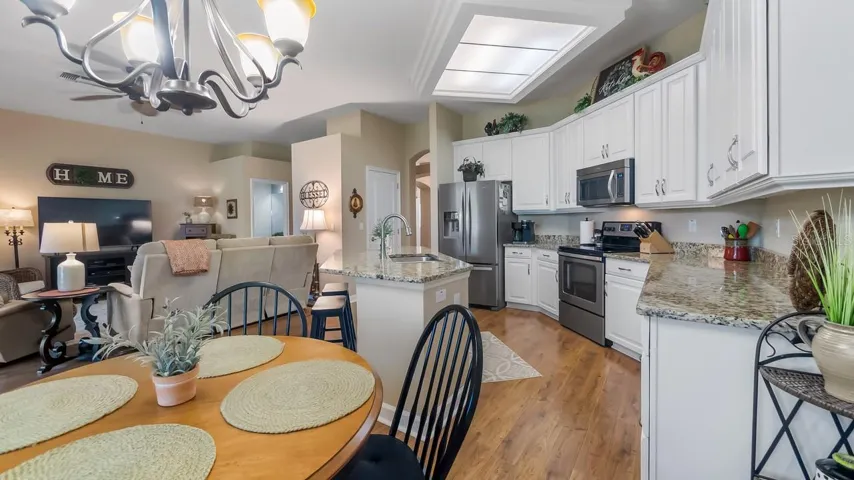 Spacious Eat In Kitchen With Wood Cabinets and Granite Counter Tops Plus a Breakfast Bar