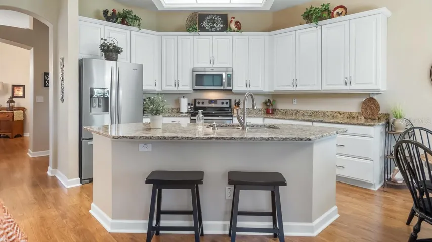 Kitchen with Breakfast Bar Wood Cabinets and Granite Counter Tops