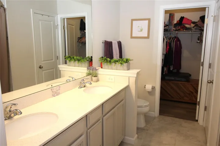 primary bath with additional walk-in closet